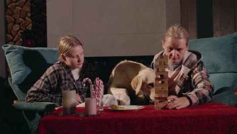 family playing with dog at home during the holidays