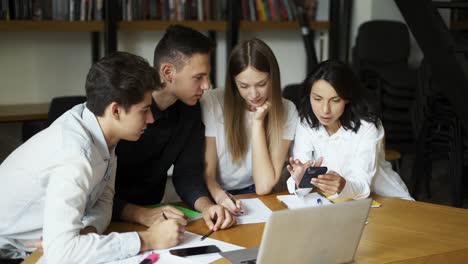 Group-of-students,-high-school-pupils-gather-in-college-library,-discuss-topics,-work-together-on-creative-task,-prepare-for