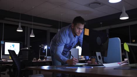 businessman working in a modern office by night