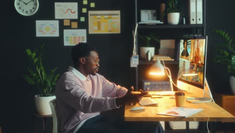 black man having web conference with business team in office