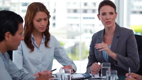 Female-boss-talking-to-her-employees