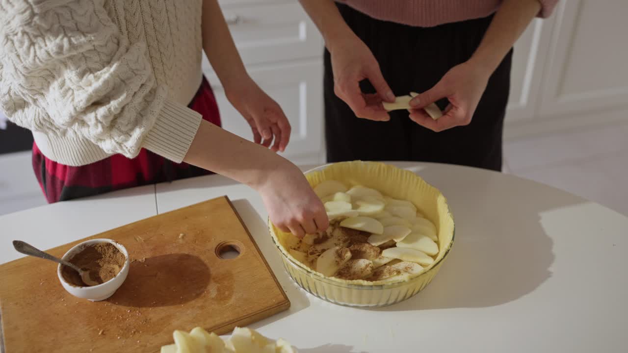 People making apple pie