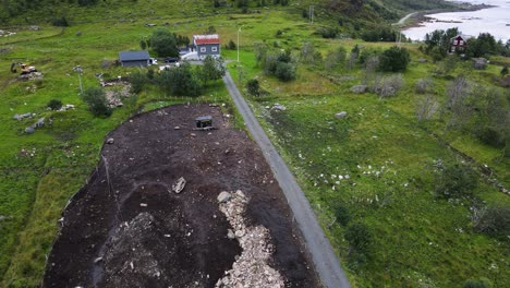 Birds-flying-over-farm-land-in-Lofoten,-Norway