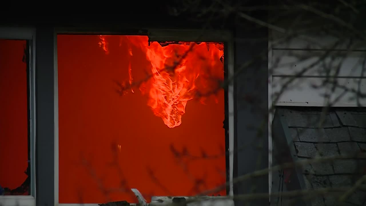 FIRE FLAMES INSIDE A HOUSE WINDOW