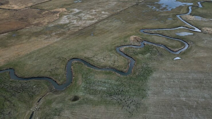 Aerial view of a meander meandering through the landscape of the Podlasie region in Poland