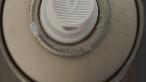 used spray can top with arrow sign, top down above moving down shot