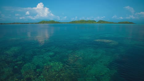 beautiful cinemagraph / seamless video loop of tropical pacific paradise islands of karimunjawa in indonesia / thailand / asia with almost no waves, clean, clear blue and turquoise water, coral reef and jungle forest.  aerial drone bird view in 4k uhd.