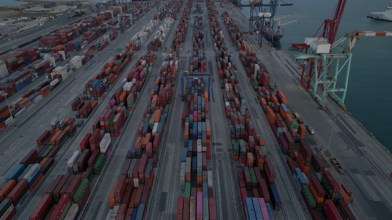 Revealing Aerial shot of shipping Containers Terminal in the evening, Valencia Spain