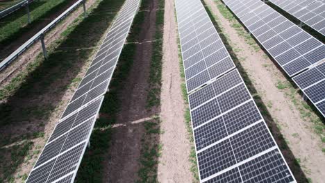 Slow-pass-over-vertical-rows-of-carbon-positive-solar-photovoltaic-panels,-green-energy