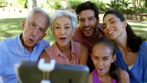 family taking a selfie in the park 4k