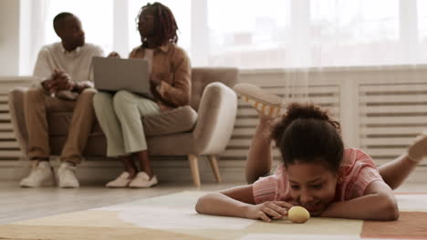 playing with colored egg on floor