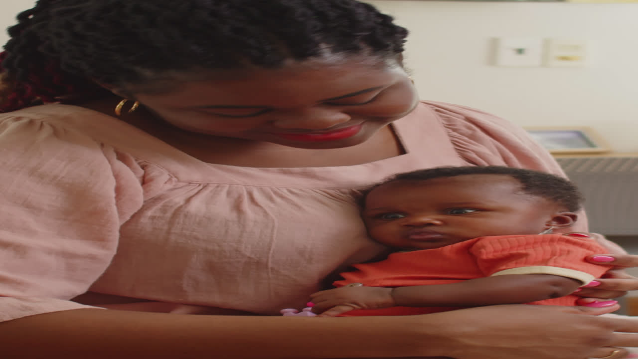 Black Mother Holding Baby on Laps