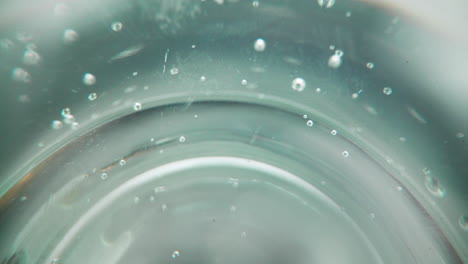 air bubbles inside delicious sparkling water in clean glass