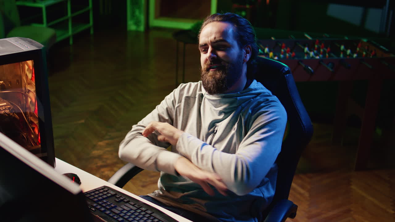 Content creator looking at webcam, chatting with audience while playing online multiplayer videogame