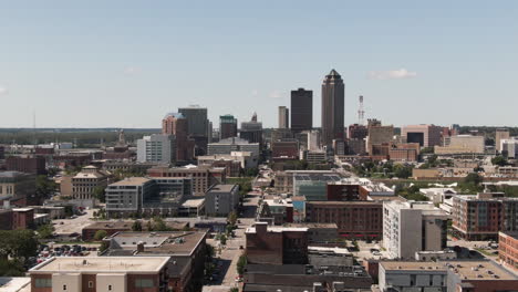 wide angle aerial tracking shot of downtown des moines, iowa on a clear summer day