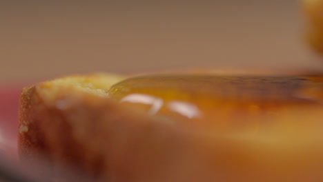 Macro-shot-of-liquid-sweet-honey-served-on-toasted-bread