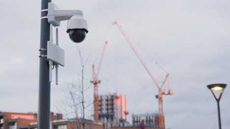 close up of surveillance camera outside buildings in london uk