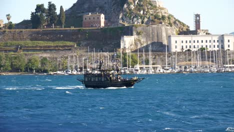 a tourist pirate ship sailing through the choppy waters of the ionian sea near corfu island