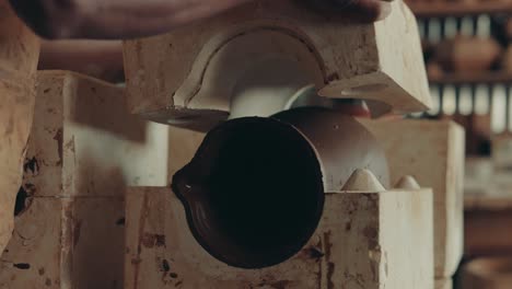 Worker-Carefully-Removing-The-Ceramic-Casting-Mold-At-Pottery-In-Antigua-Guatemala,-Central-America