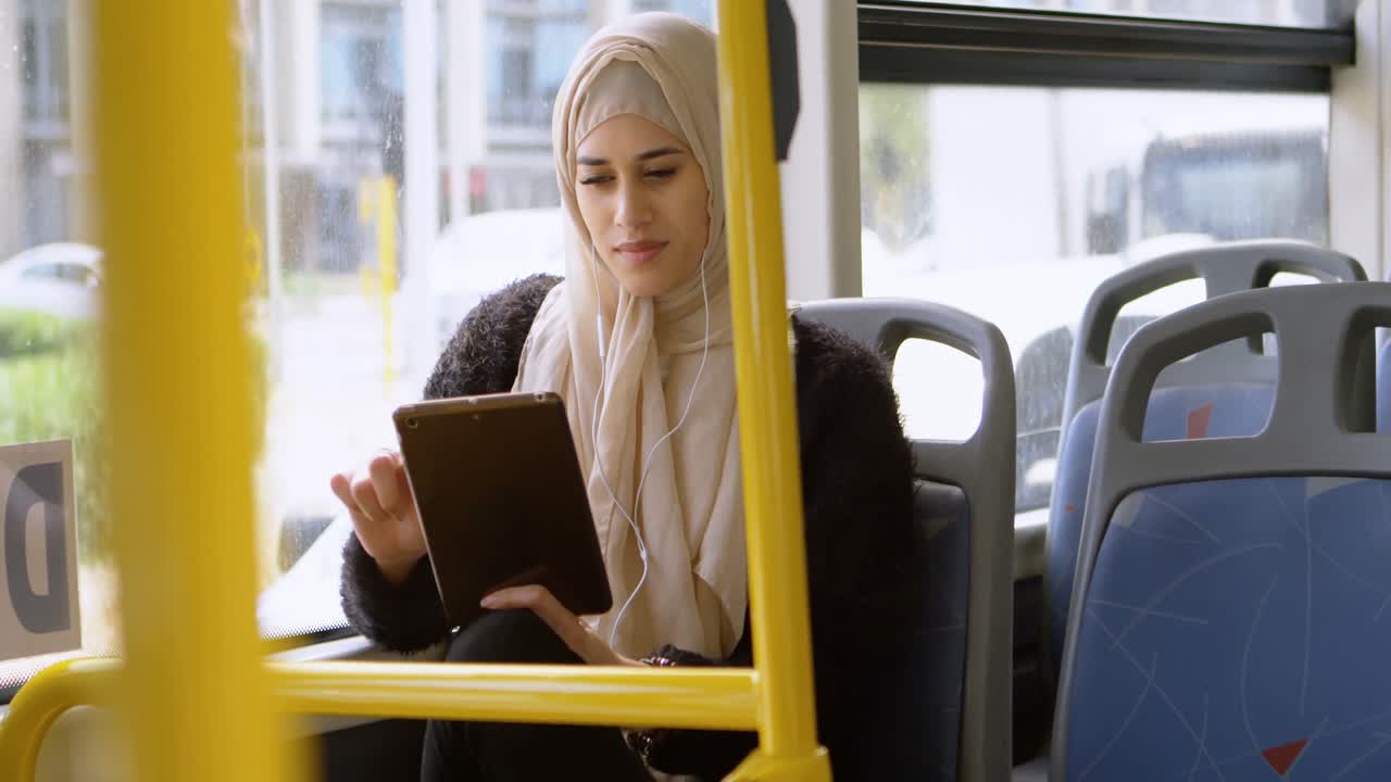 Woman in hijab using digital tablet 4k