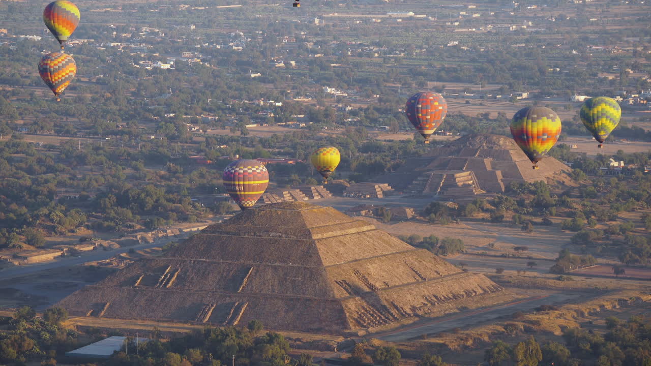 Hot air balloons flying over ancient Teotihuacan pyramids