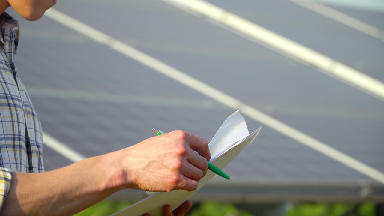 Close up of engineer hands checks solar panels productivity