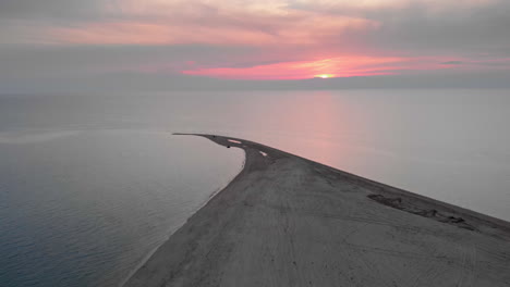 Drone-video-ascending-over-empty-beach-summer-Greece-at-sunset