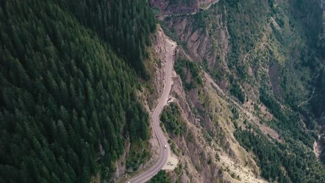 high angle shot of a mountain road next to a cliff