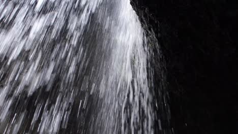 close view of fast flowing mountain stream of waterfall from cliff