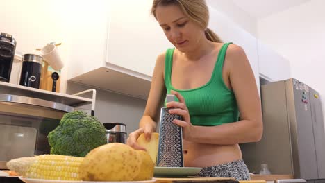 woman grating cheese in a kitchen