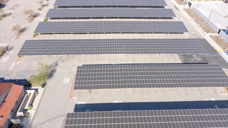 Solar-panels-provide-renewable,-clean-energy-and-shade-in-a-parking-lot---ascending-aerial