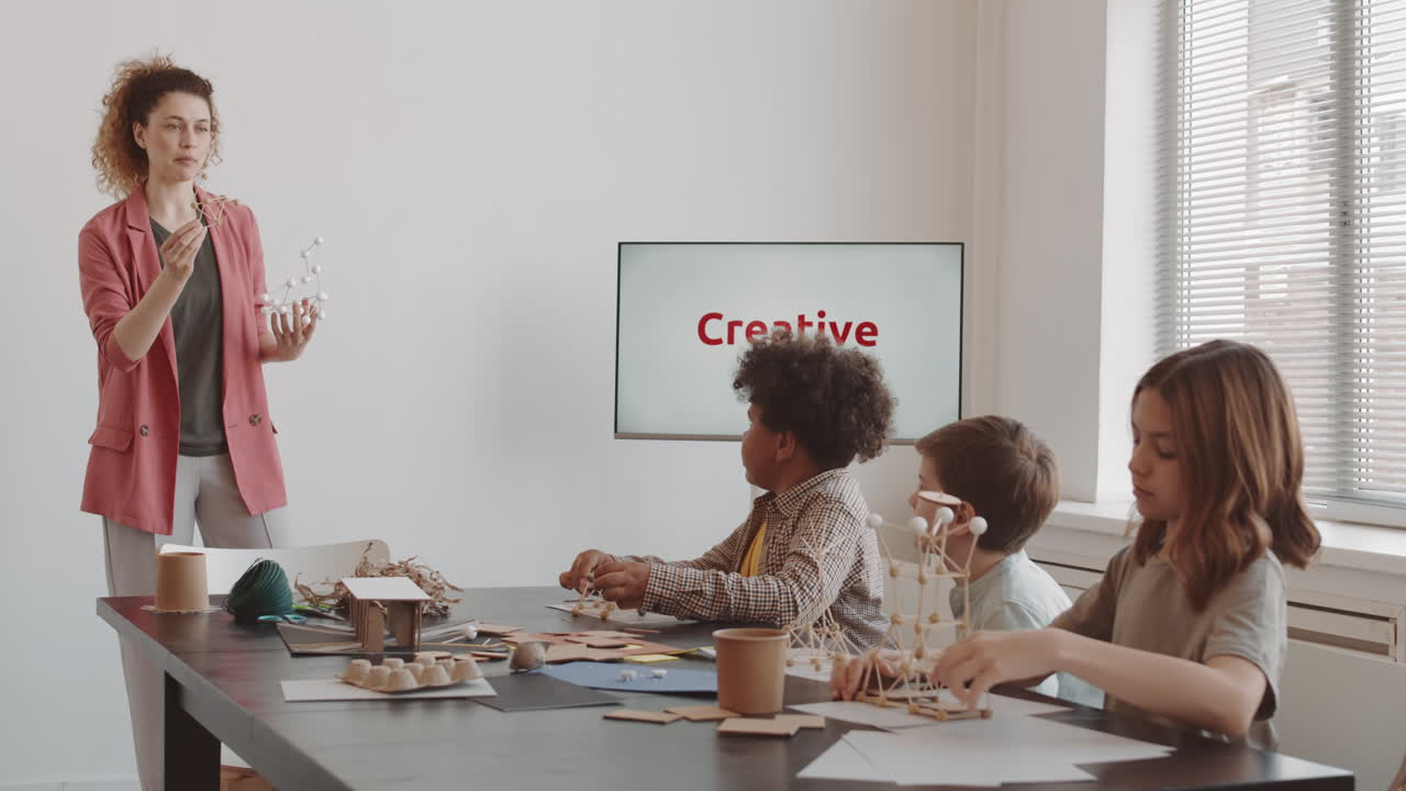 Woman Showing Framework Model to Class