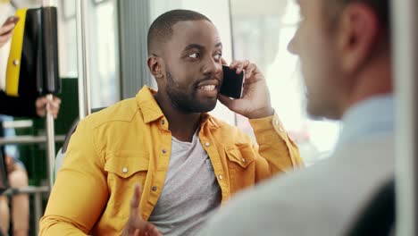 Attractive-Happy-Guy-Talking-On-The-Phone-While-Going-In-The-Tram