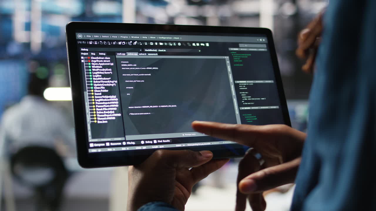 Close up of data center software developer checking code on tablet