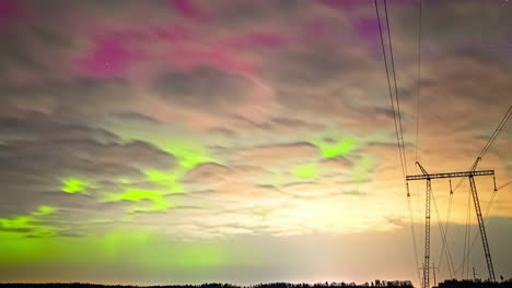 starry sky with clouds in time lapse and aurora borealis over transmission tower