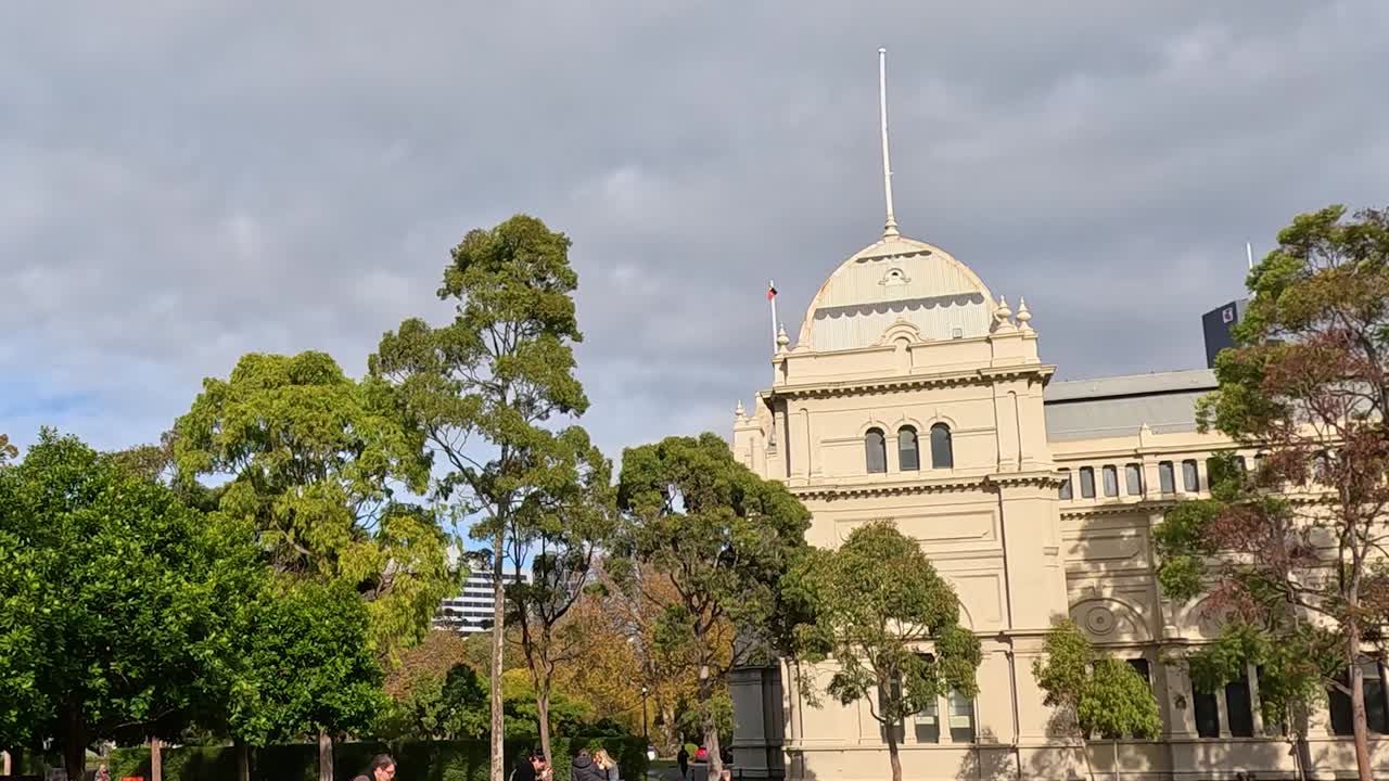 A view of the iconic dome surrounded by vibrant trees and people enjoying a sunny day.
