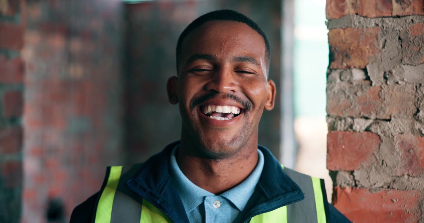 Portrait of a Smiling Construction Worker in a Building Site