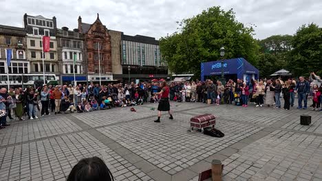 performer entertains crowd in edinburgh, scotland