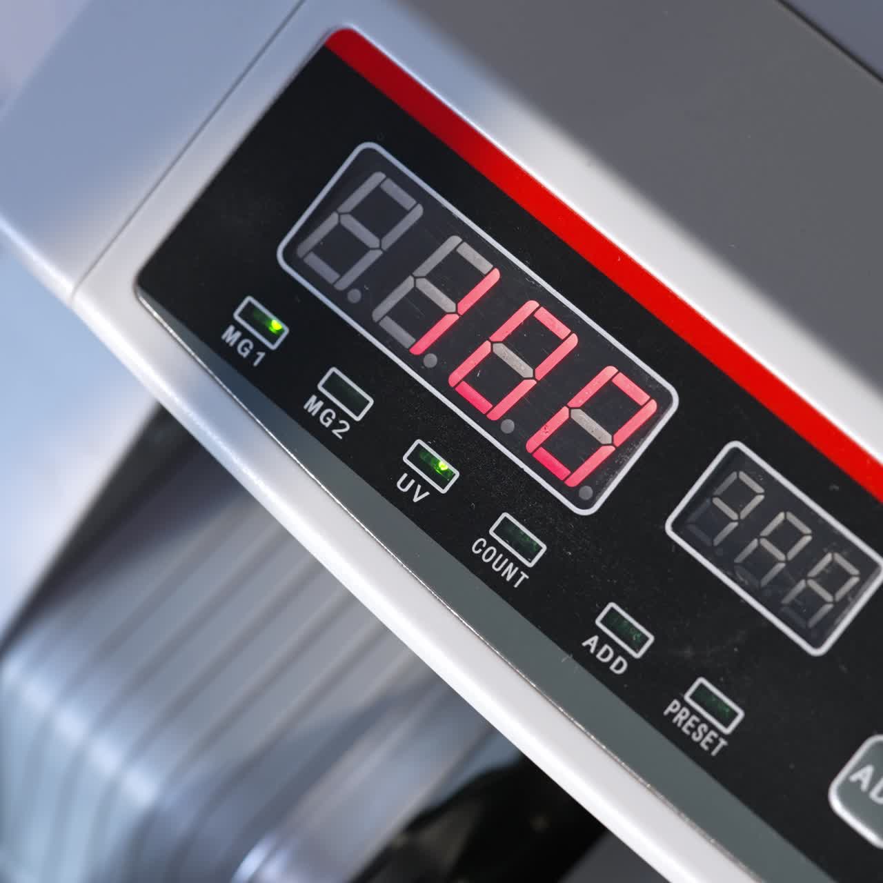 Electronic cash counting equipment working. Unrecognized banknotes turning quickly in machine. Close up