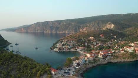 aerial pullback from beautiful coastal village scenery, assos village, greek island