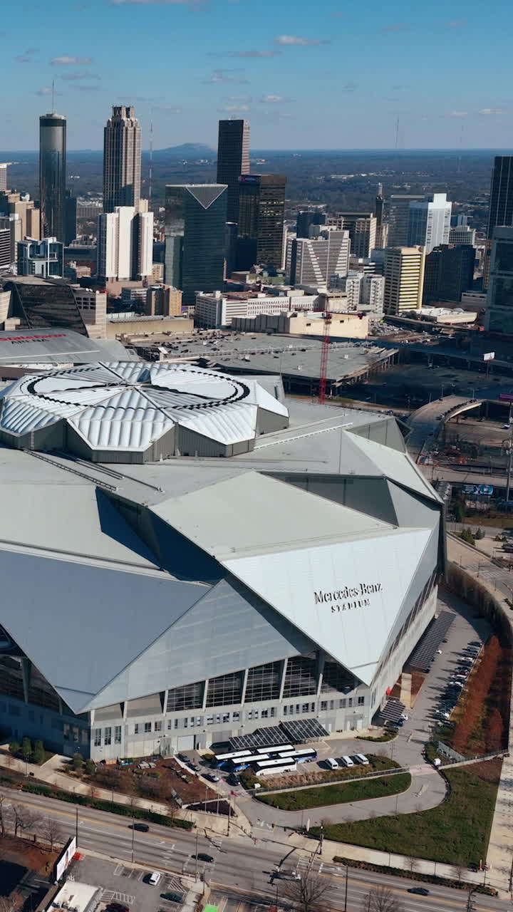 Atlanta, Georgia, USA - January 02, 2024: Aerial view of Mercedes-Benz Stadium. City center with skyscrapers on winter sunny day. Vertical video