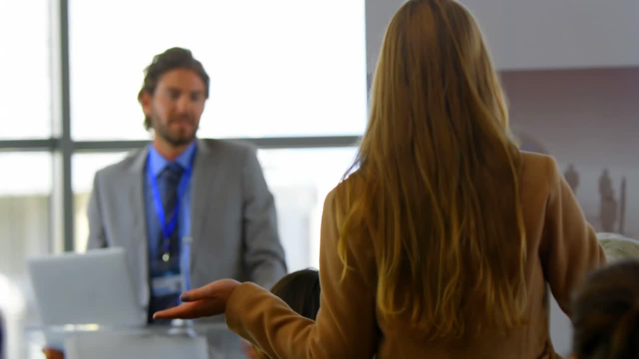 Businesswoman interacting with a male speaker in the business seminar 4k