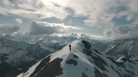 a mountaineer goes to the summit through the snow - italian alps in south tyrol