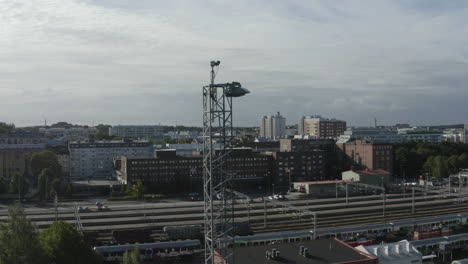 drone view flying near high lamp above empty train depot