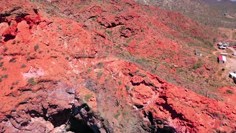 people climbing red mountain on the beach