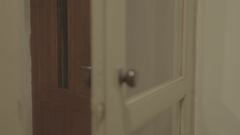 Vintage-wooden-door-with-glass-panel-in-an-old-building