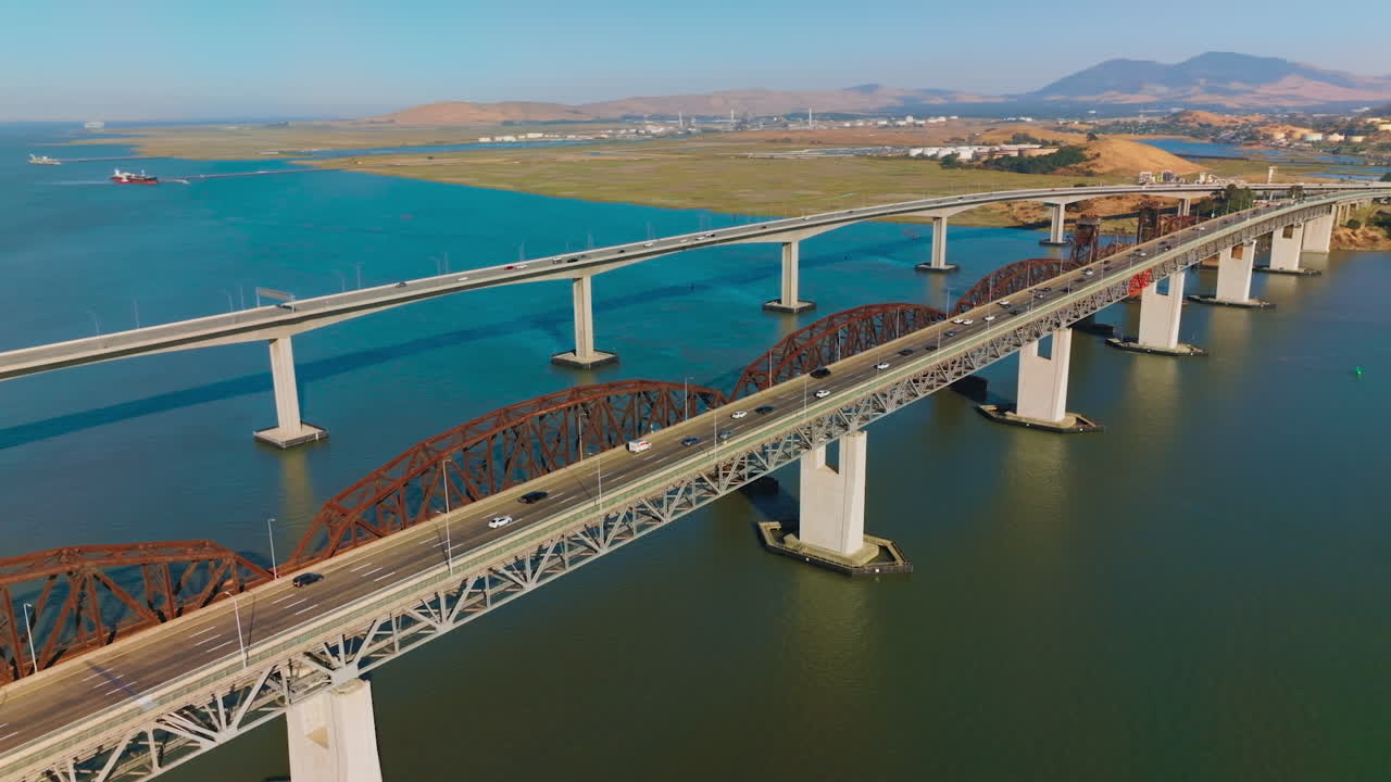 Lively traffic by the bridges connecting Martinez to Benicia. Beautiful scenery of the bay California, USA on clear bright sunny day.