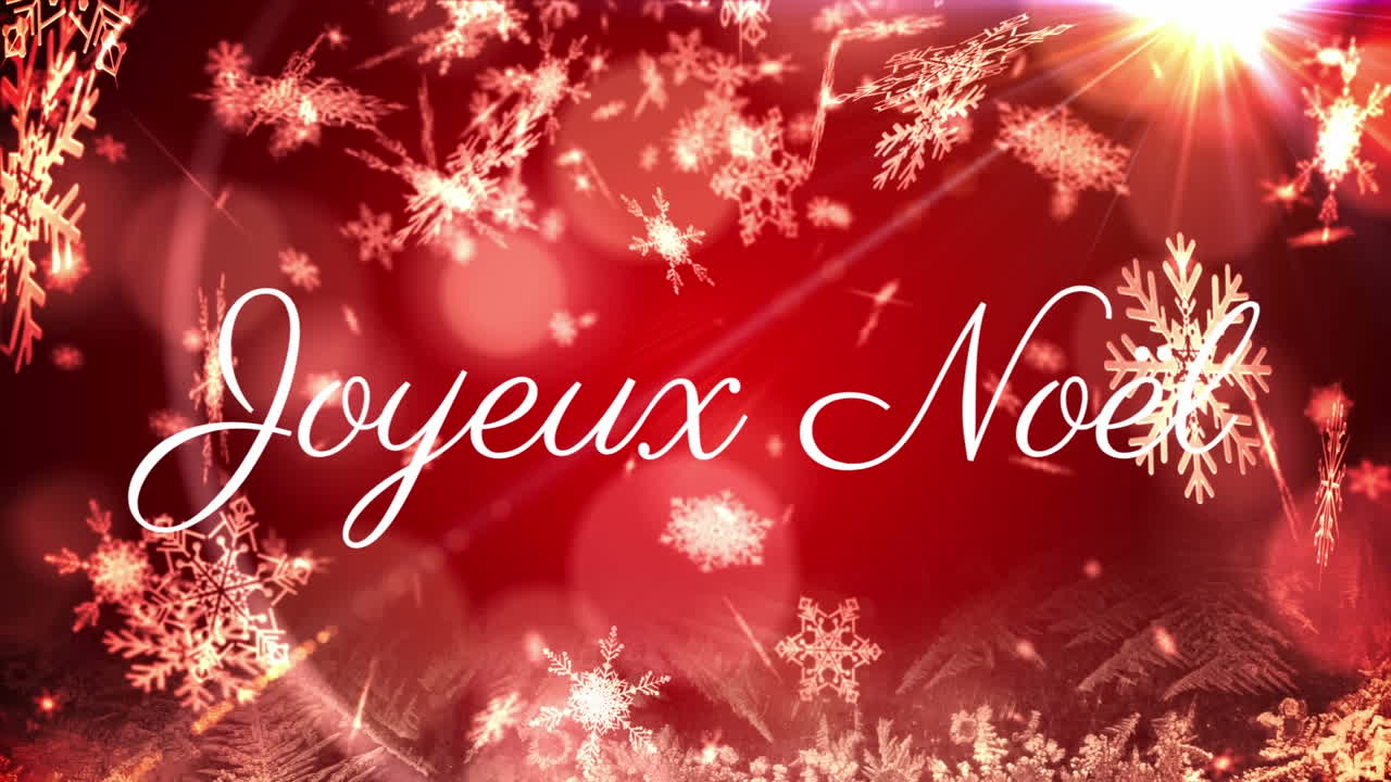 Animazione del testo 'Joyeux Noël' su sfondo rosso con neve che cade.