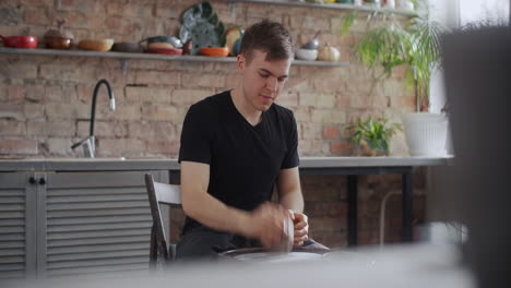 man working on pottery wheel in kitchen