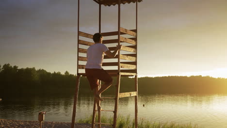 male lifeguard going up to the watchtower